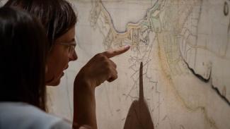 Person looking and pointing finger at the Map of Vauban