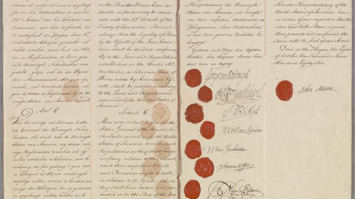 A two-page document dating back to 1782 with calligraphy writing. On the right page representatives have signed the treaty, using their signatures and wax seals.