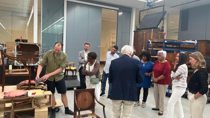 Cynthia McLeod (dressed in red) visited the Netherlands Collection Centre (CC-NL) with a small group on June 24, after her lecture at the Cultural Heritage Agency. Together with furniture restorer Stephan de Vries, they viewed the furniture that is on loan to the Elisabeth Samsonhuis.  